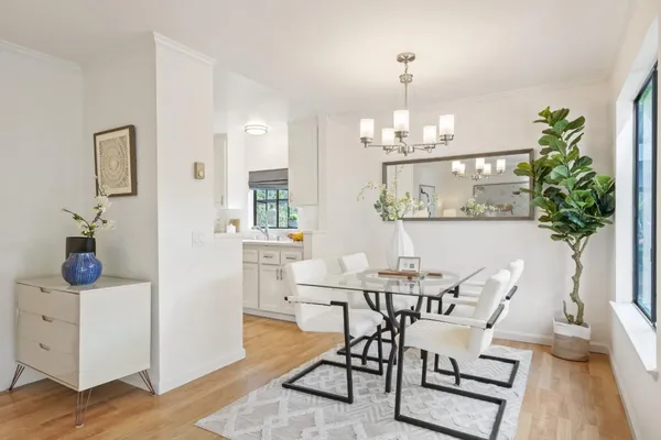 a view of a dining room with furniture and chandelier