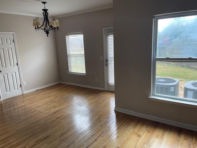 1105 Thornebrooke Court Suwanee, GA 30024 - Photo 27 of 31 a view of an empty room with a window and wooden floor