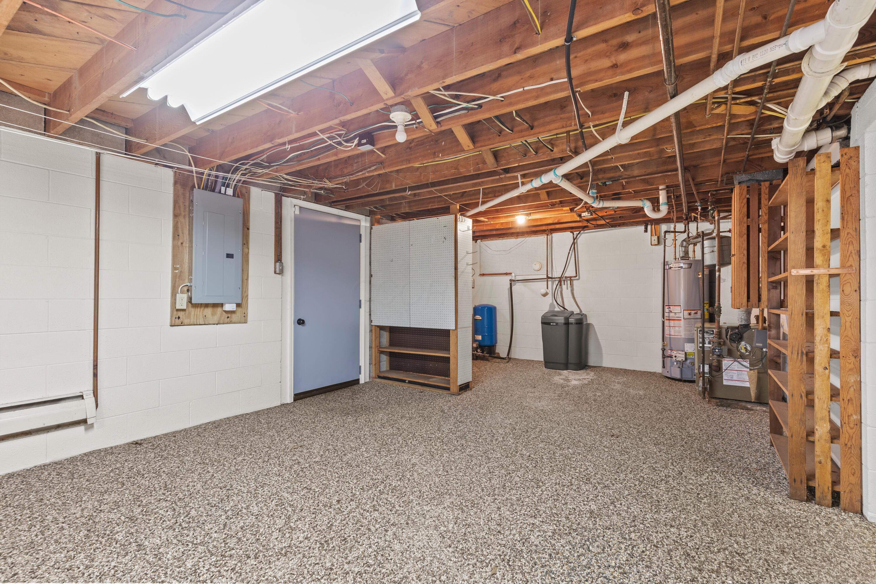 6982 Lee Road Westerville, OH 43081 - Photo 59 of 71 • New epoxy flooring ~ 2018/2020 • New sump pump ~ 2025 • Glass block windows • Electric dryer hookup • Walks-up to rear yard with Bilco® steel doors • New sewer piping ~ 2024 • Baseboard heat • AO Smith® pressure tank • AO Smith® water softener (owned) • AO Smith® gas water heater • Sears® natural gas boiler • Laundry chute outlet • New sewer piping ~ 2024