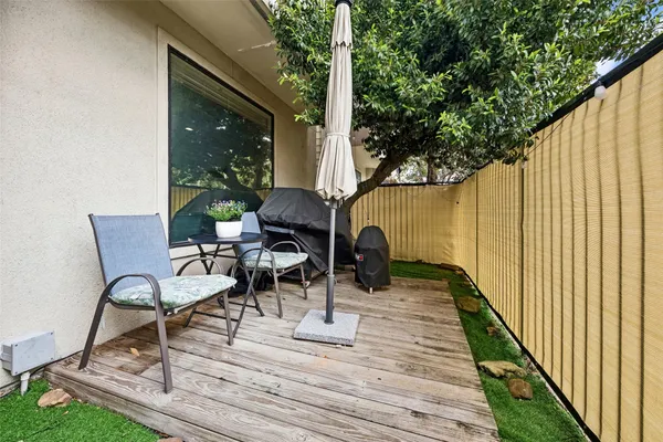 a view of balcony with chairs and wooden fence
