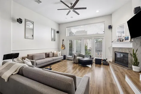 a living room with furniture a fireplace and a flat screen tv