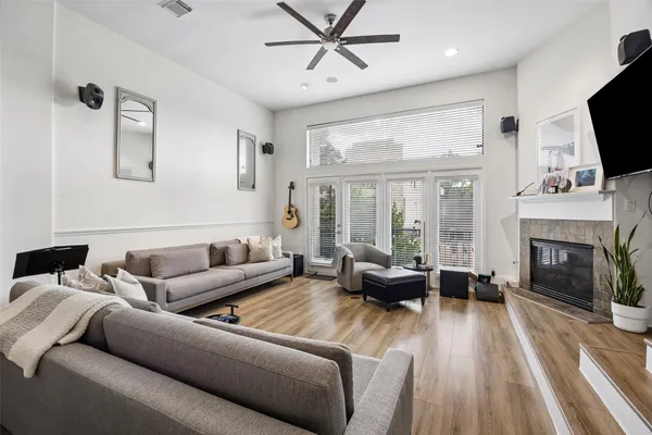 a living room with furniture a fireplace and a flat screen tv