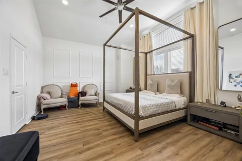 a bedroom with bed couch and window