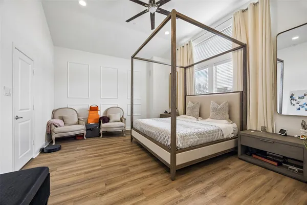 a bedroom with bed couch and window