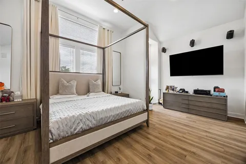 a bed room with a bed and a flat screen tv