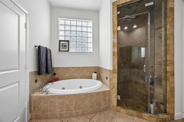 a bathroom with a tub and shower