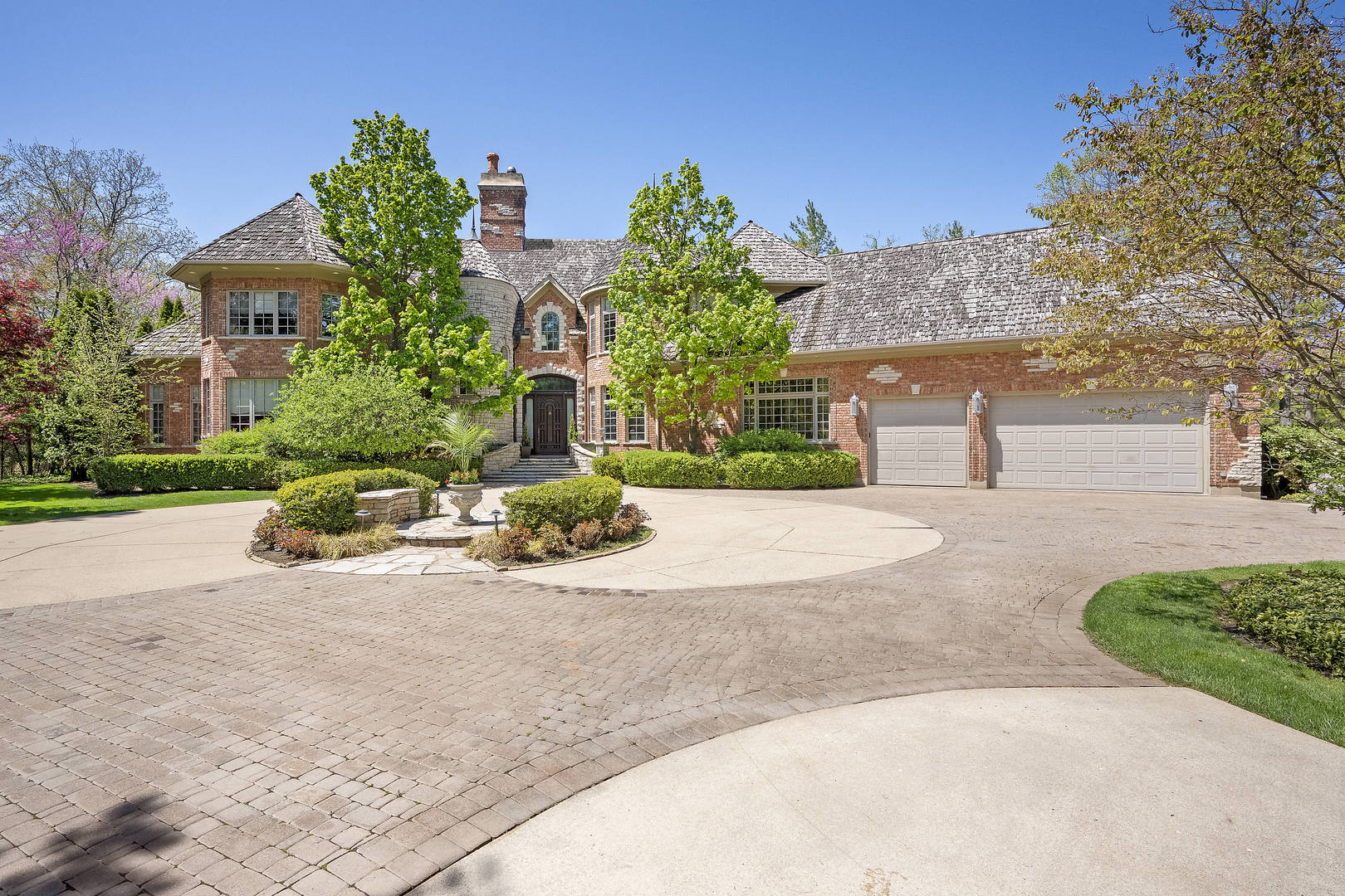 a front view of a house with a yard and a garage