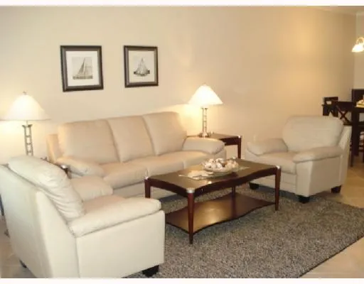 a living room with furniture and a lamp