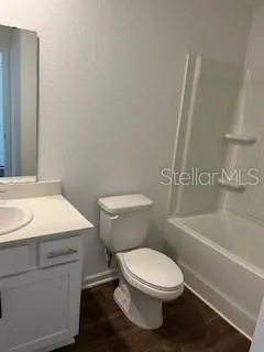 a white toilet sitting next to a bath tub