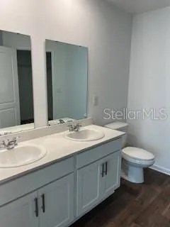 a bathroom with a toilet sink and mirror