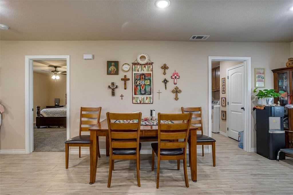 2140 Brown Loop Poolville, TX 76487 - Photo 12 of 38 a view of a dining room with furniture and wooden floor