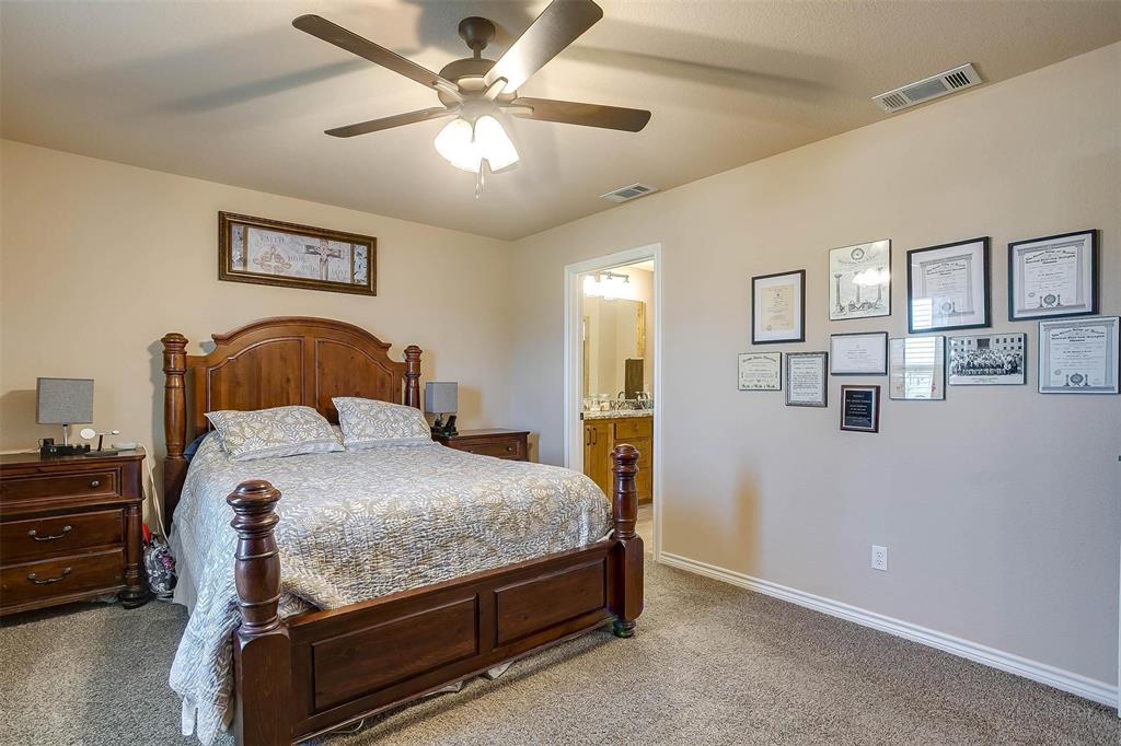 2140 Brown Loop Poolville, TX 76487 - Photo 15 of 38 a bedroom with a bed and a ceiling fan