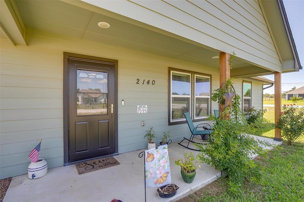 2140 Brown Loop Poolville, TX 76487 - Photo 2 of 38 a front view of a house with outdoor seating