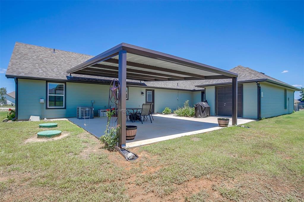 2140 Brown Loop Poolville, TX 76487 - Photo 32 of 38 a view of a house with backyard porch and sitting area