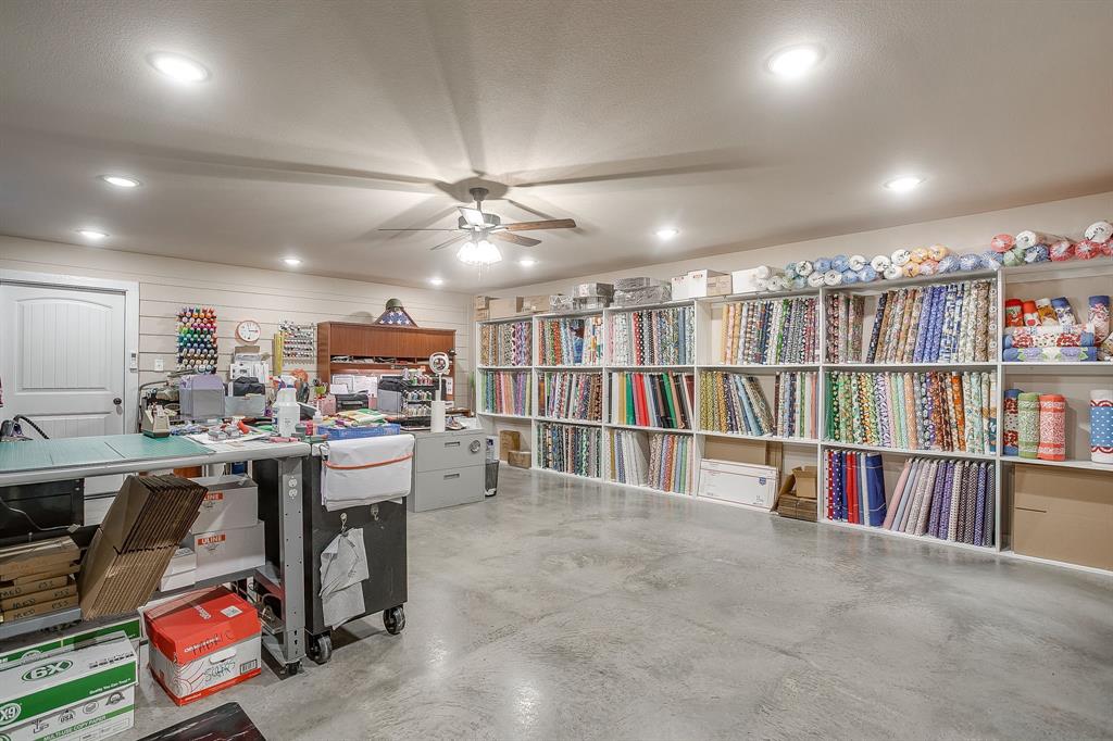 2140 Brown Loop Poolville, TX 76487 - Photo 36 of 38 a room with lots of furniture and a book shelf