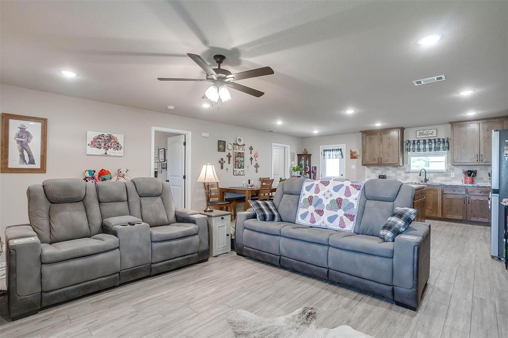 2140 Brown Loop Poolville, TX 76487 - Photo 4 of 38 a living room with furniture kitchen view and a chandelier