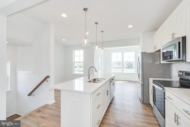 a kitchen with a sink a stove and refrigerator