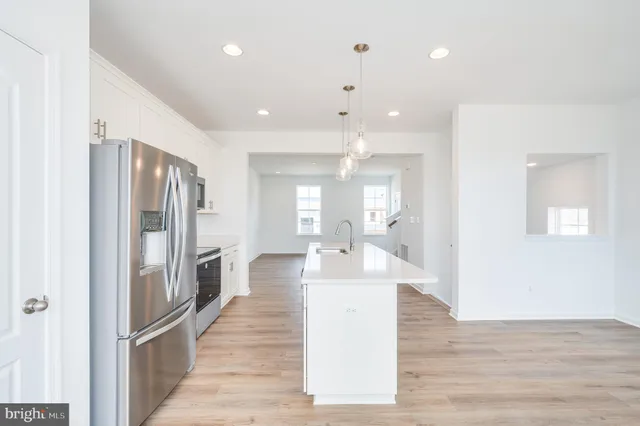 a view of a room with wooden floor and white walls