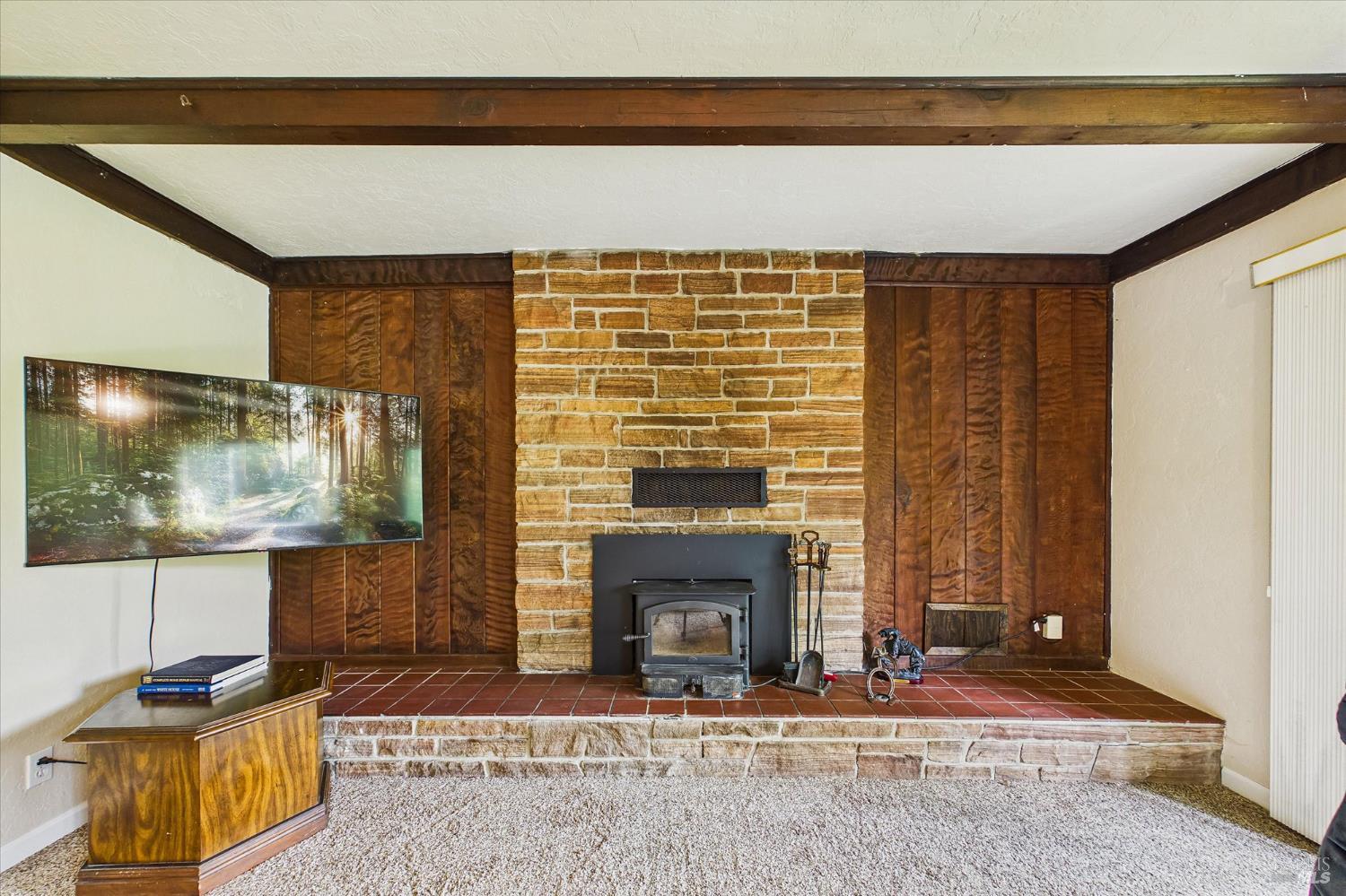 305 Belleview Avenue Rio Dell, CA 95562 - Photo 18 of 76 a living room with a fireplace and a flat screen tv