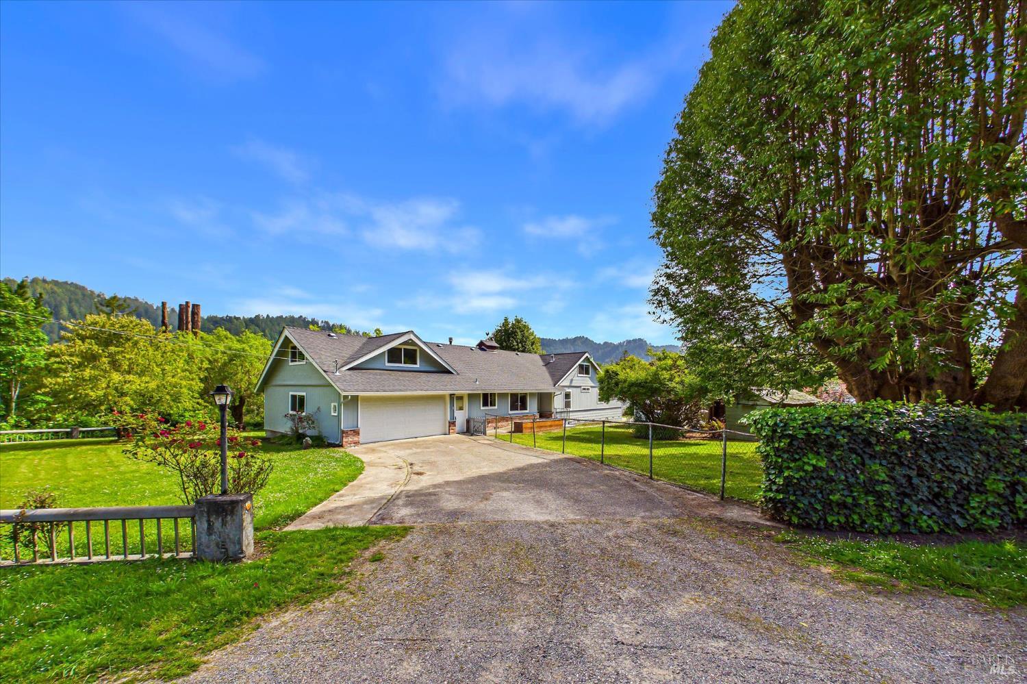 305 Belleview Avenue Rio Dell, CA 95562 - Photo 2 of 76 a view of a house with a big yard and large trees