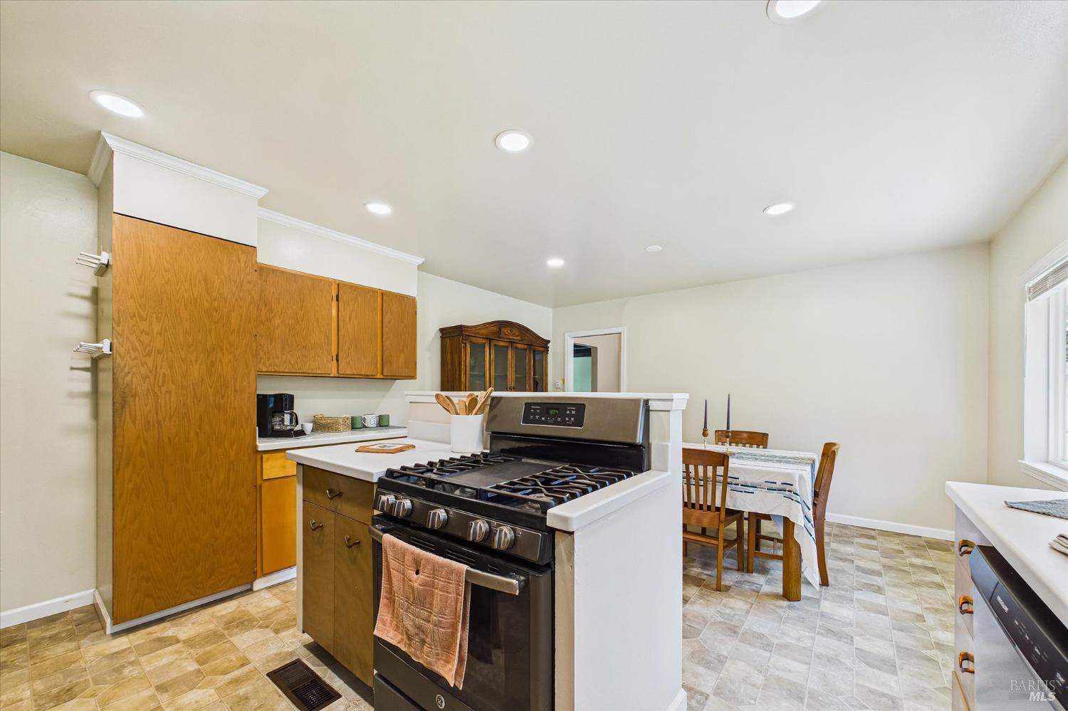 305 Belleview Avenue Rio Dell, CA 95562 - Photo 26 of 76 a kitchen with stainless steel appliances granite countertop a stove top oven a sink a dining table and chairs