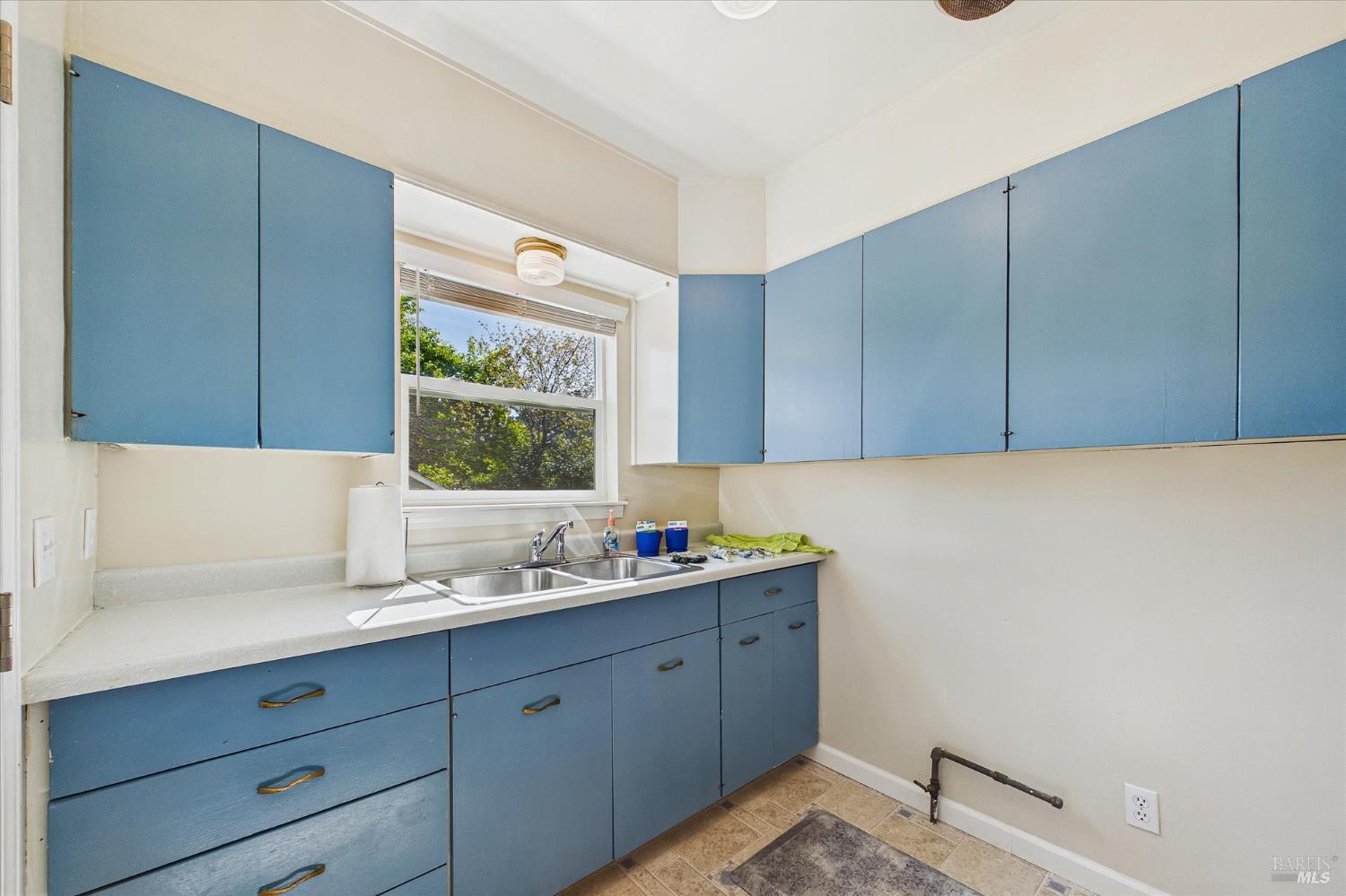 305 Belleview Avenue Rio Dell, CA 95562 - Photo 47 of 76 a kitchen with a sink window and cabinets