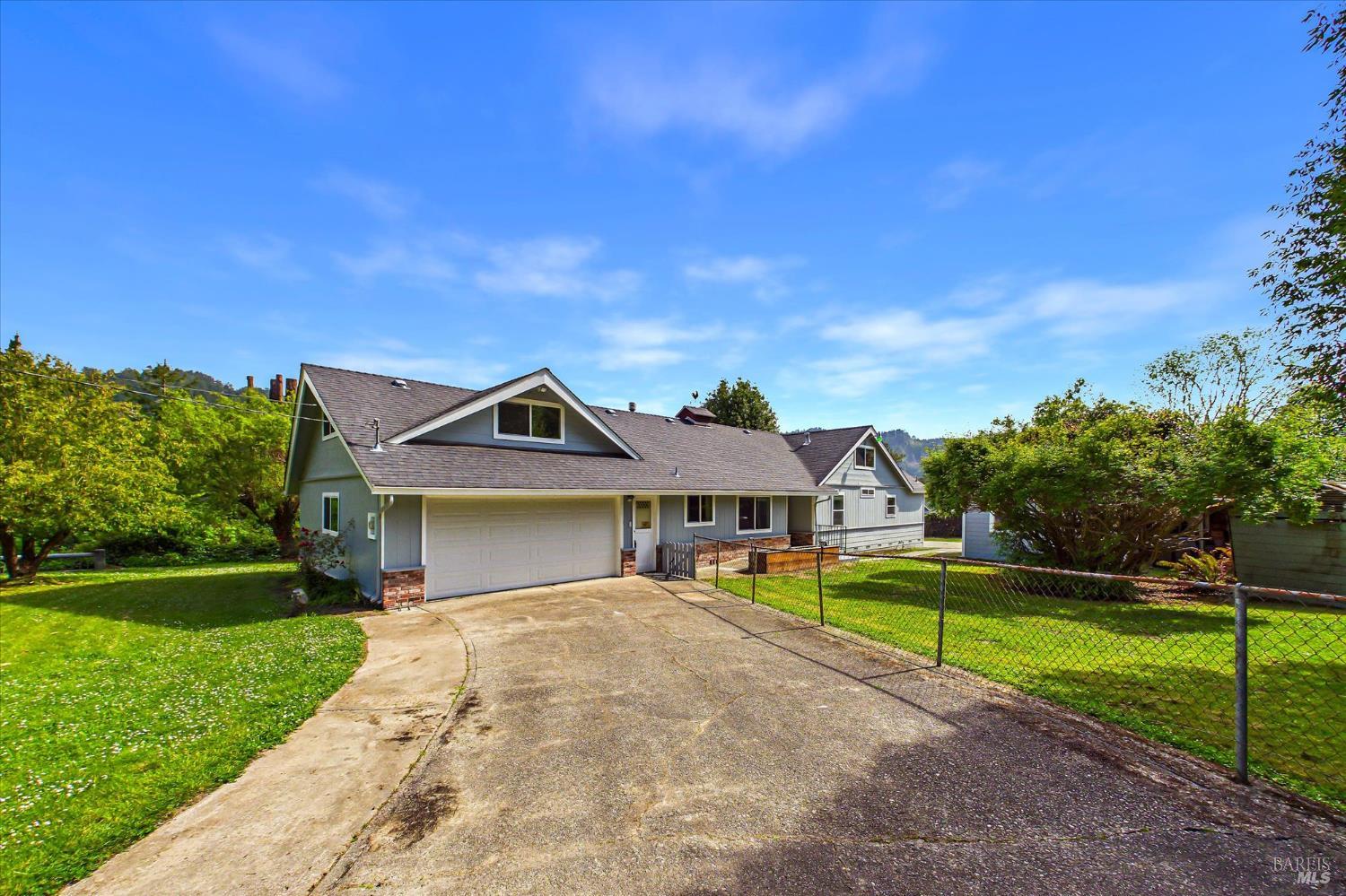 305 Belleview Avenue Rio Dell, CA 95562 - Photo 9 of 76 a front view of a house with a yard and trees