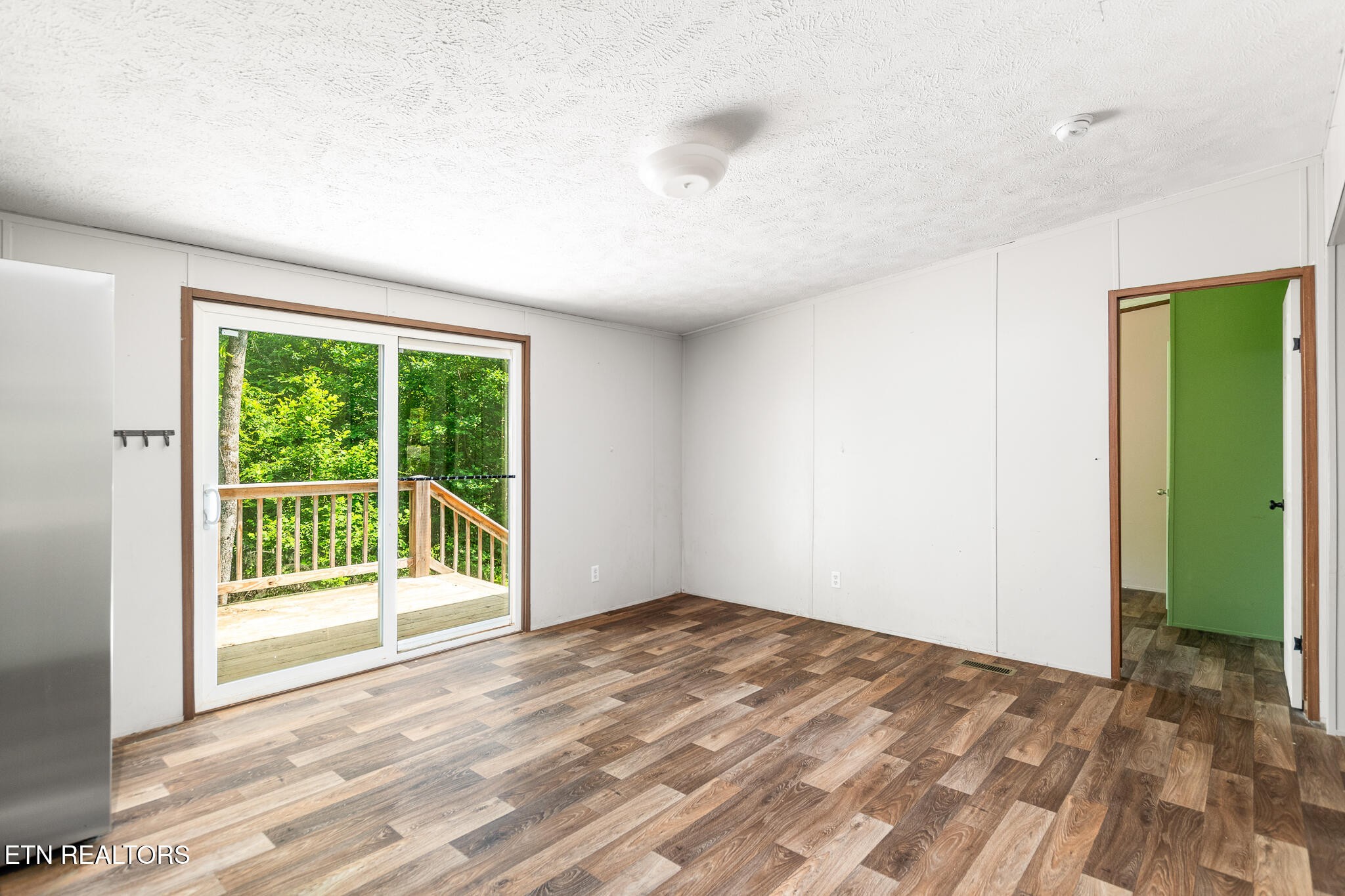 297 Wells Road Powell, TN 37849 - Photo 3 of 15 a view of empty room with wooden floor and fan