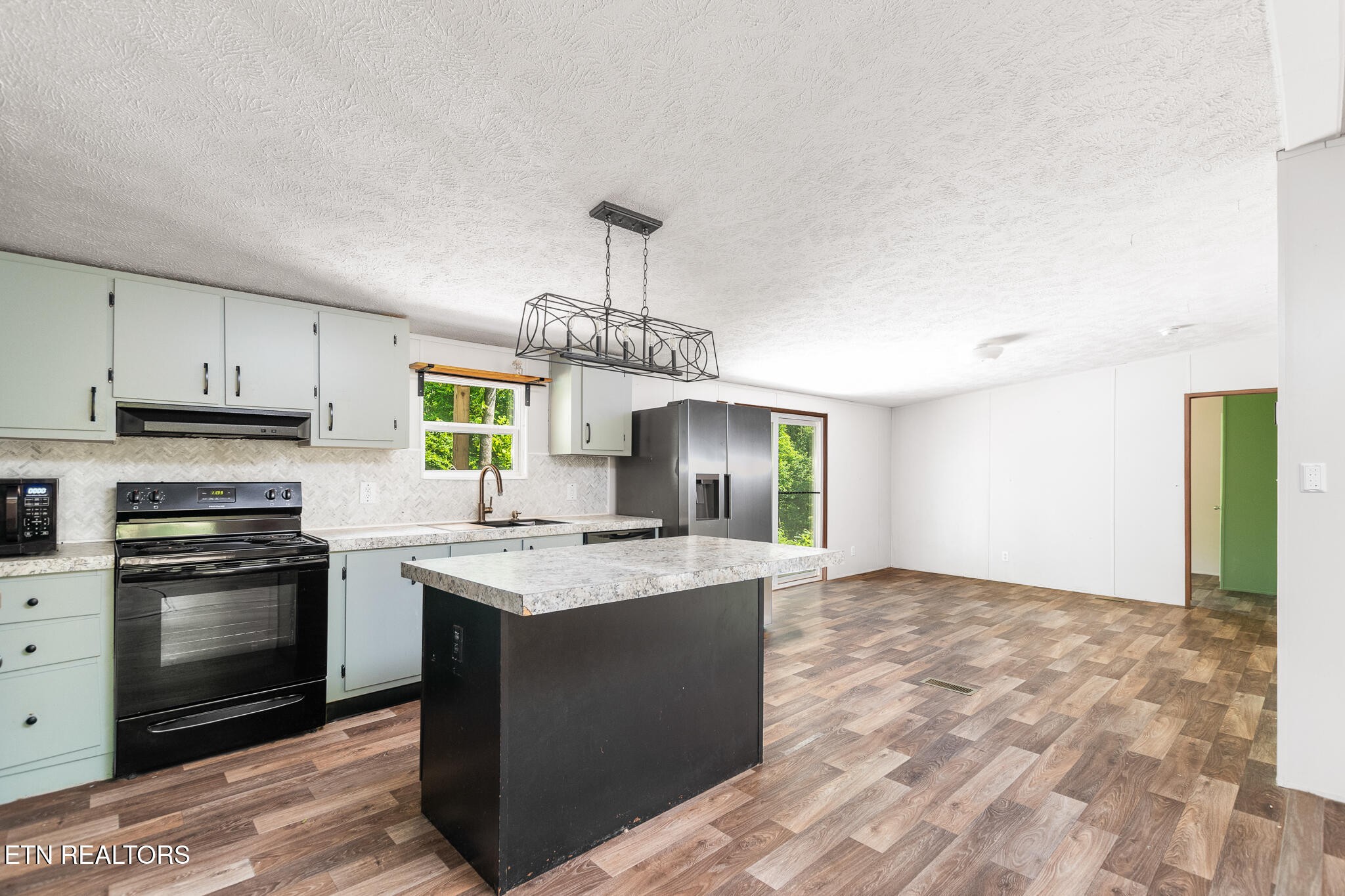 297 Wells Road Powell, TN 37849 - Photo 4 of 15 a kitchen with a stove and a sink