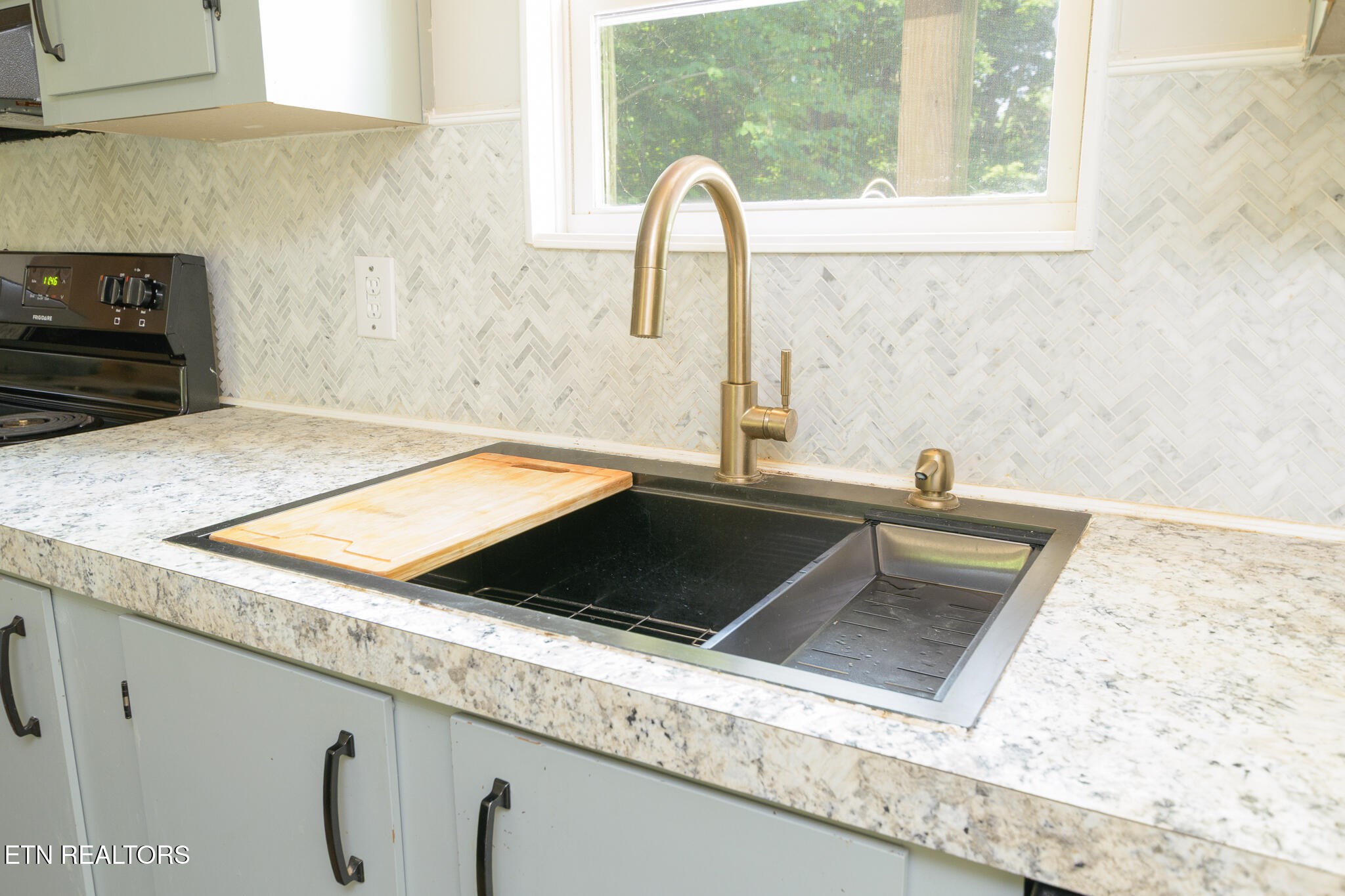 297 Wells Road Powell, TN 37849 - Photo 7 of 15 a kitchen with a sink and a stove
