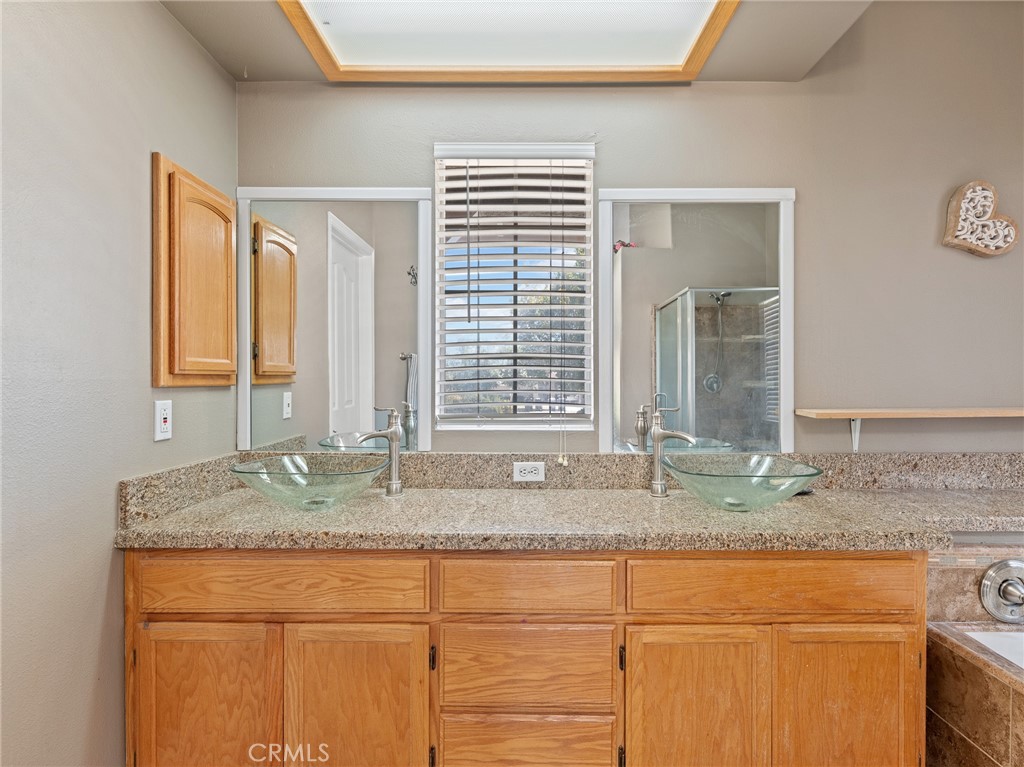 12949 Choco Road Apple Valley, CA 92308 - Photo 13 of 48 a bathroom with granite countertop granite countertop a sink and a mirror