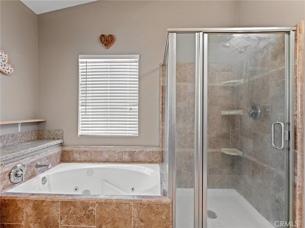 12949 Choco Road Apple Valley, CA 92308 - Photo 14 of 48 a bathroom with a bathtub and shower