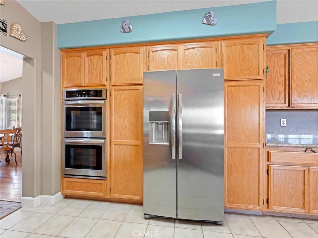 12949 Choco Road Apple Valley, CA 92308 - Photo 16 of 48 a kitchen with stainless steel appliances granite countertop a refrigerator and a stove top oven