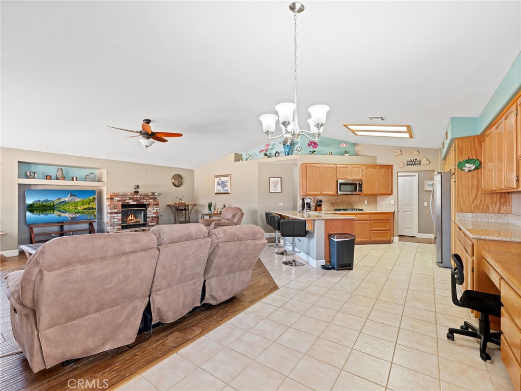 12949 Choco Road Apple Valley, CA 92308 - Photo 19 of 48 a living room with fireplace furniture and a chandelier