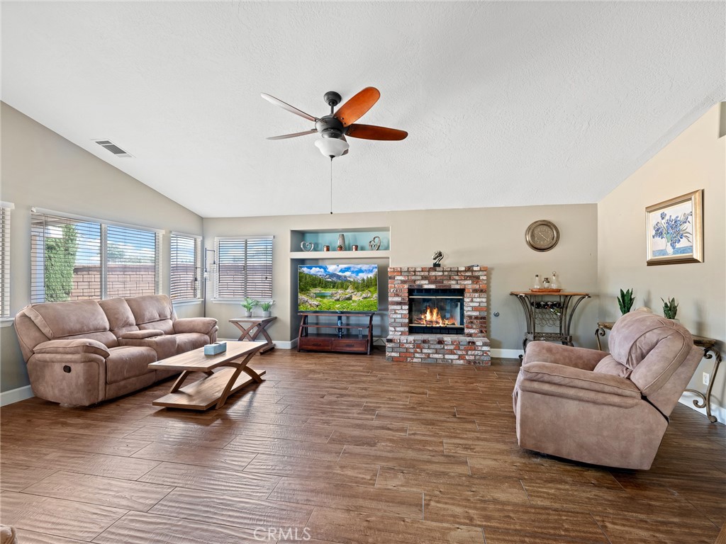 12949 Choco Road Apple Valley, CA 92308 - Photo 21 of 48 a living room with furniture and a fireplace