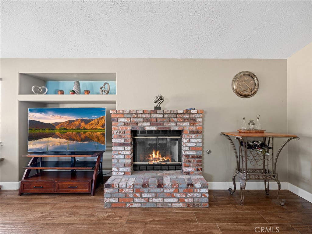 12949 Choco Road Apple Valley, CA 92308 - Photo 22 of 48 a living room with furniture and a fireplace