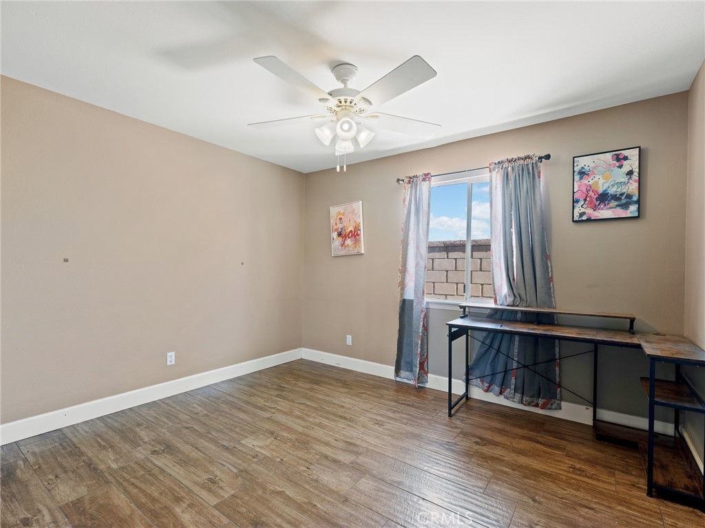 12949 Choco Road Apple Valley, CA 92308 - Photo 27 of 48 wooden floor in an empty room with a window