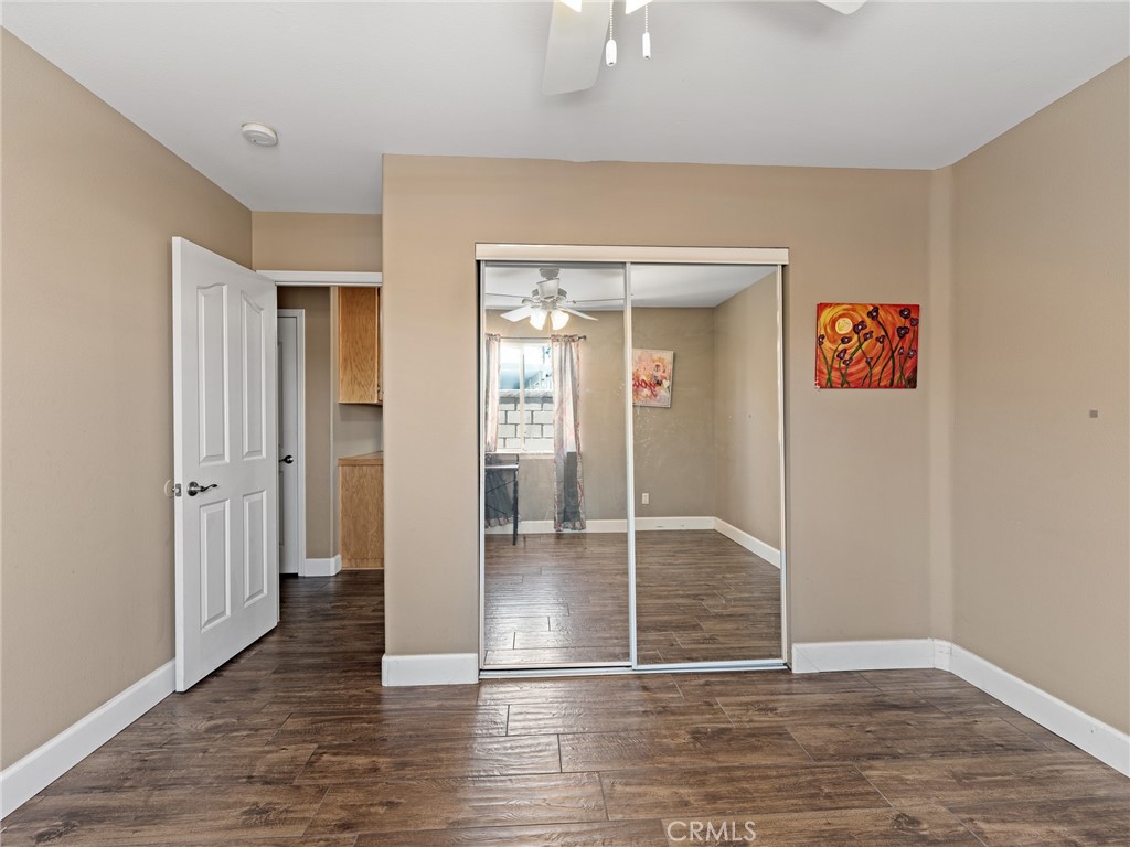 12949 Choco Road Apple Valley, CA 92308 - Photo 28 of 48 an empty room with wooden floor and windows