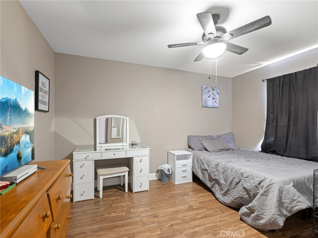 12949 Choco Road Apple Valley, CA 92308 - Photo 29 of 48 a bedroom with a bed and a fireplace