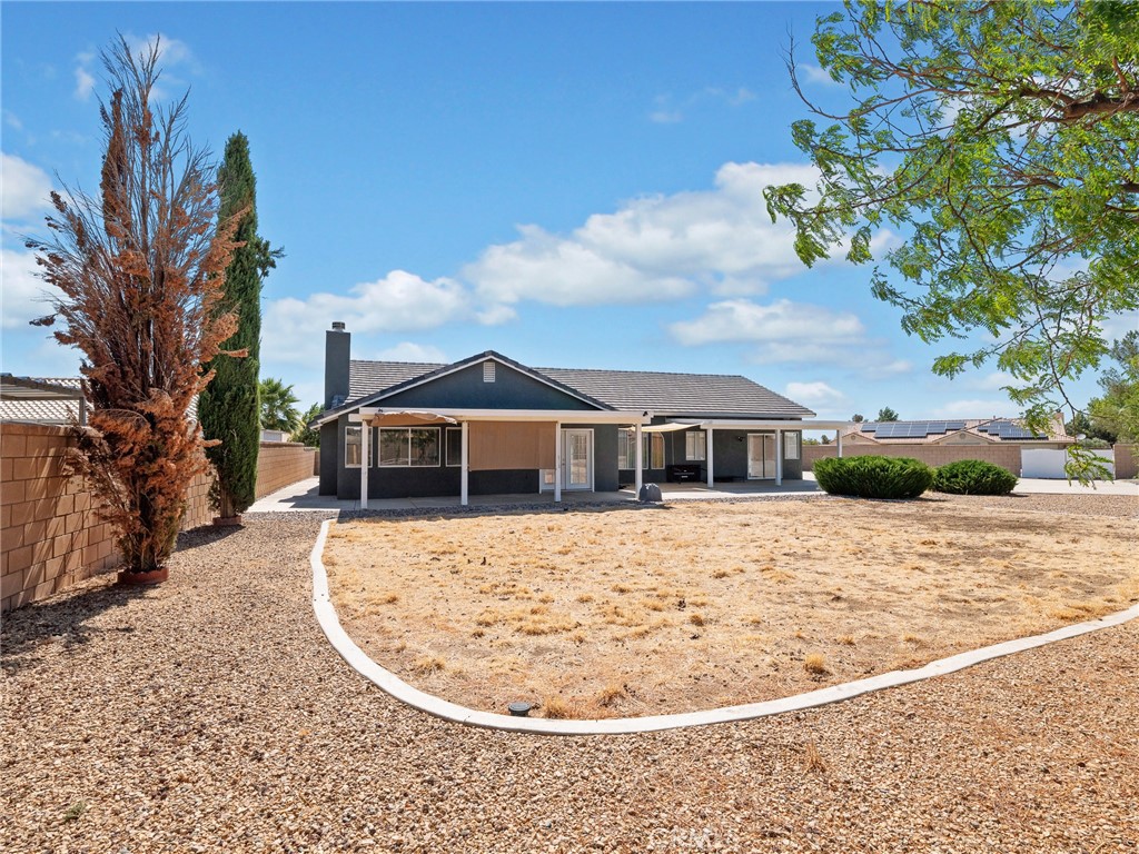 12949 Choco Road Apple Valley, CA 92308 - Photo 32 of 48 a view of a house with a wooden fence