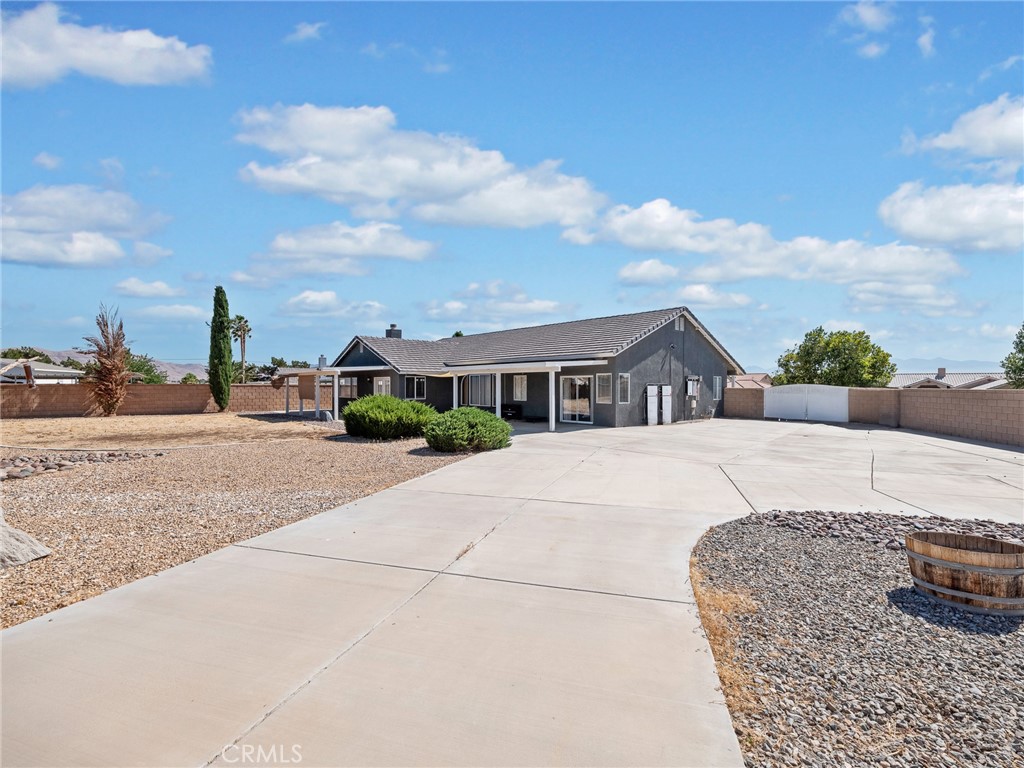 12949 Choco Road Apple Valley, CA 92308 - Photo 34 of 48 a front view of a house with a yard and garage