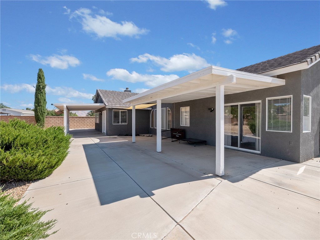 12949 Choco Road Apple Valley, CA 92308 - Photo 35 of 48 a front view of a house with a garden