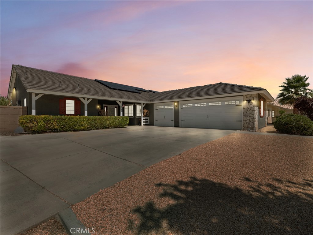 12949 Choco Road Apple Valley, CA 92308 - Photo 47 of 48 a front view of a house with a garden