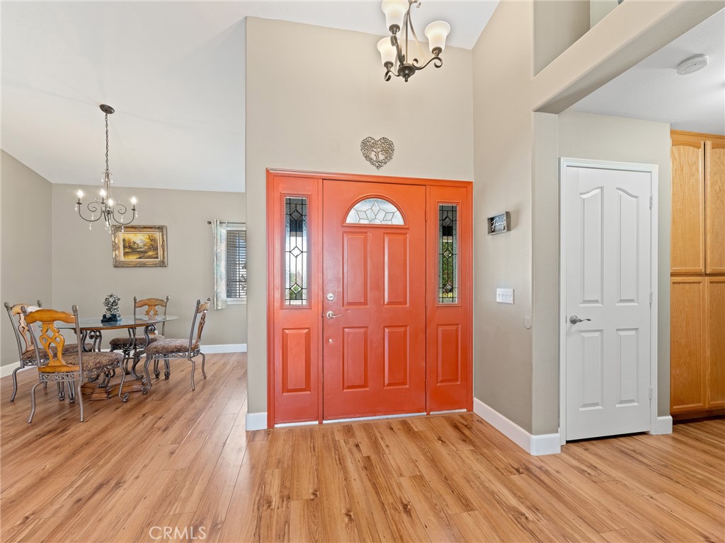 12949 Choco Road Apple Valley, CA 92308 - Photo 5 of 48 a view of a livingroom with furniture wooden floor closet and a chandelier