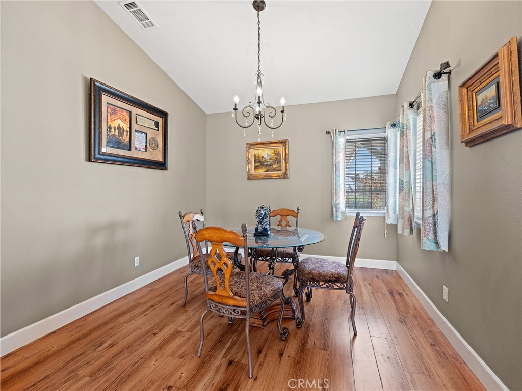12949 Choco Road Apple Valley, CA 92308 - Photo 6 of 48 a view of a dining room with furniture wooden floor and a chandelier