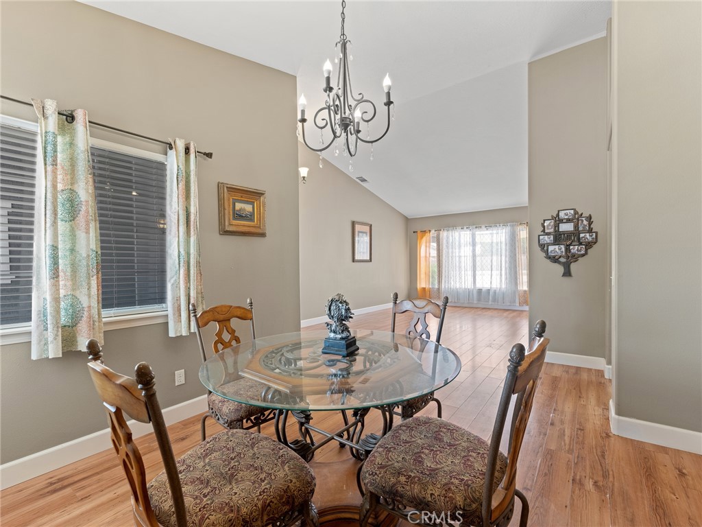 12949 Choco Road Apple Valley, CA 92308 - Photo 7 of 48 a view of a dining room with furniture window and wooden floor