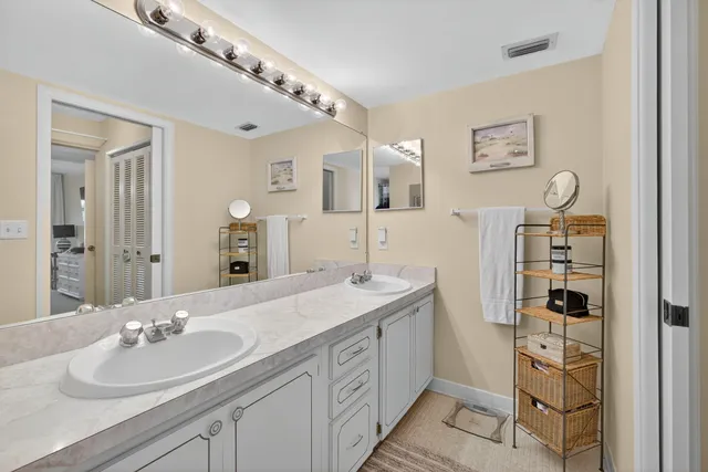 a view of a hallway with closet and bathroom