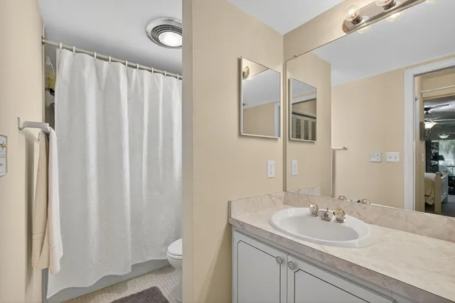 a spacious bedroom with a bed and a flat screen tv