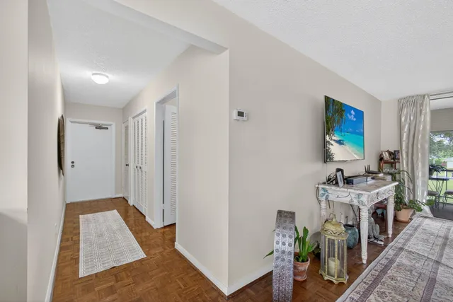 a view of a hallway with a livingroom and furniture