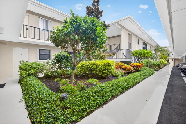 a kitchen with stainless steel appliances granite countertop a refrigerator a stove a sink a dining table and chairs